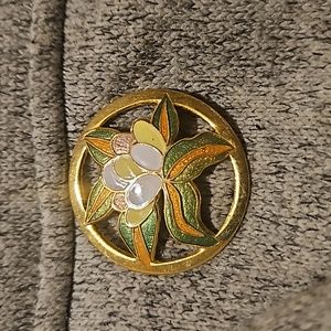 Gold colored flower brooch